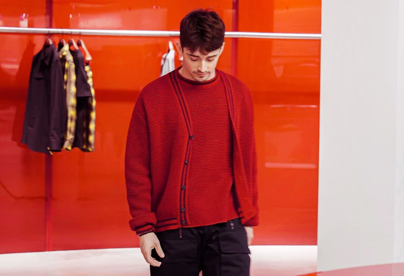 Charles Leclerc wears Ferrari knitwear in the Maranello boutique.