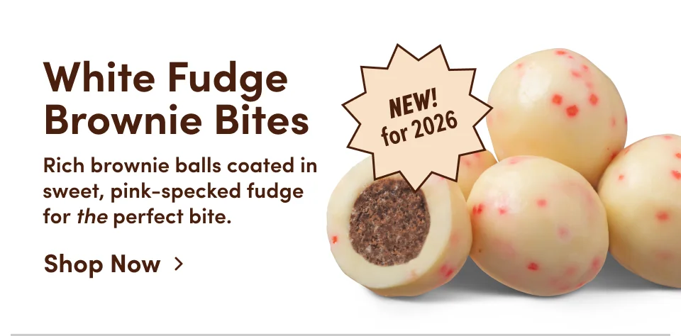 White Fudge Brownie Bites | Rich brownie balls coated in sweet, pink-specked fudge for the perfect bite; Shop now