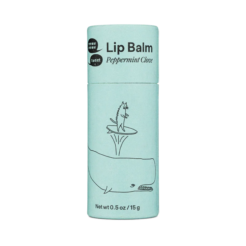 A light blue tube with black text and a cat surfing on a whale's spout drawn on i