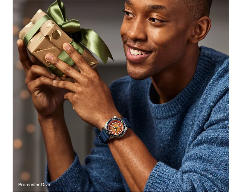 Person holding a gift box and wearing a Promaster Dive