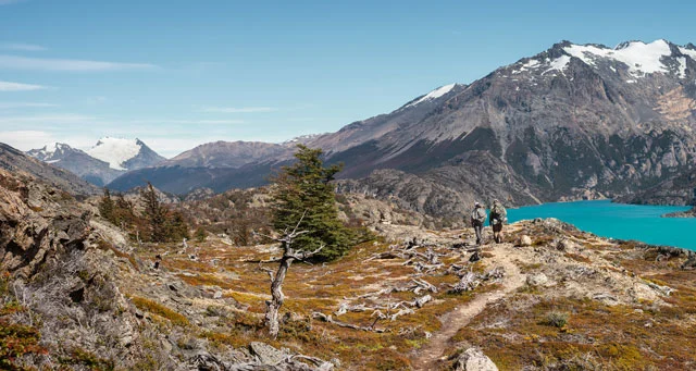 At Perito Moreno National Park in Patagonia, Argentina, trailbuilders Willie Bittner (at left) and Jed Talbot wind past the aquamarine waters of Belgrano Lake.