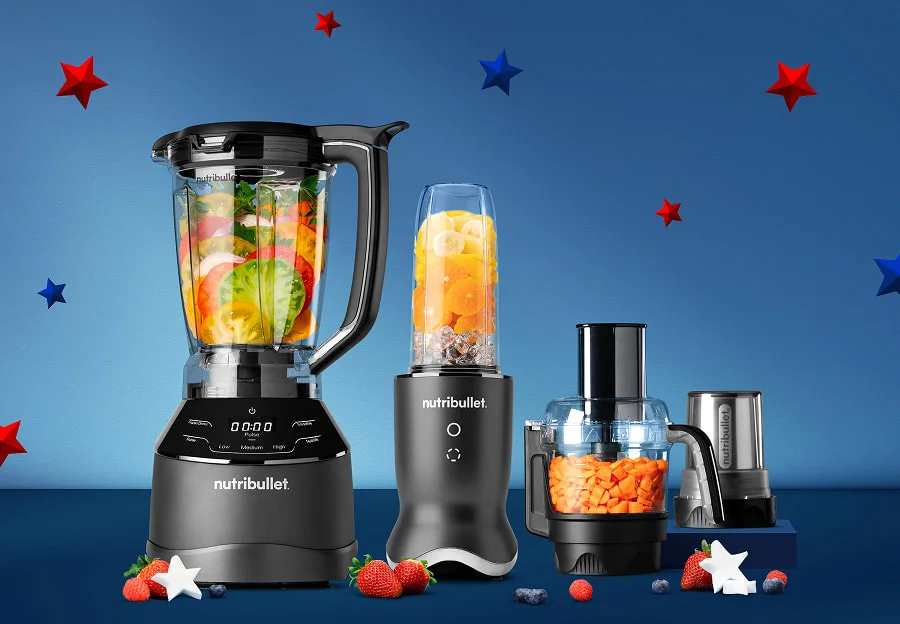 Four black nutribullet blenders and food processors filled with fruit and vegetables on a blue background with red and blue stars.