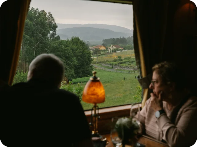 Two people looking out of a train in Spain.