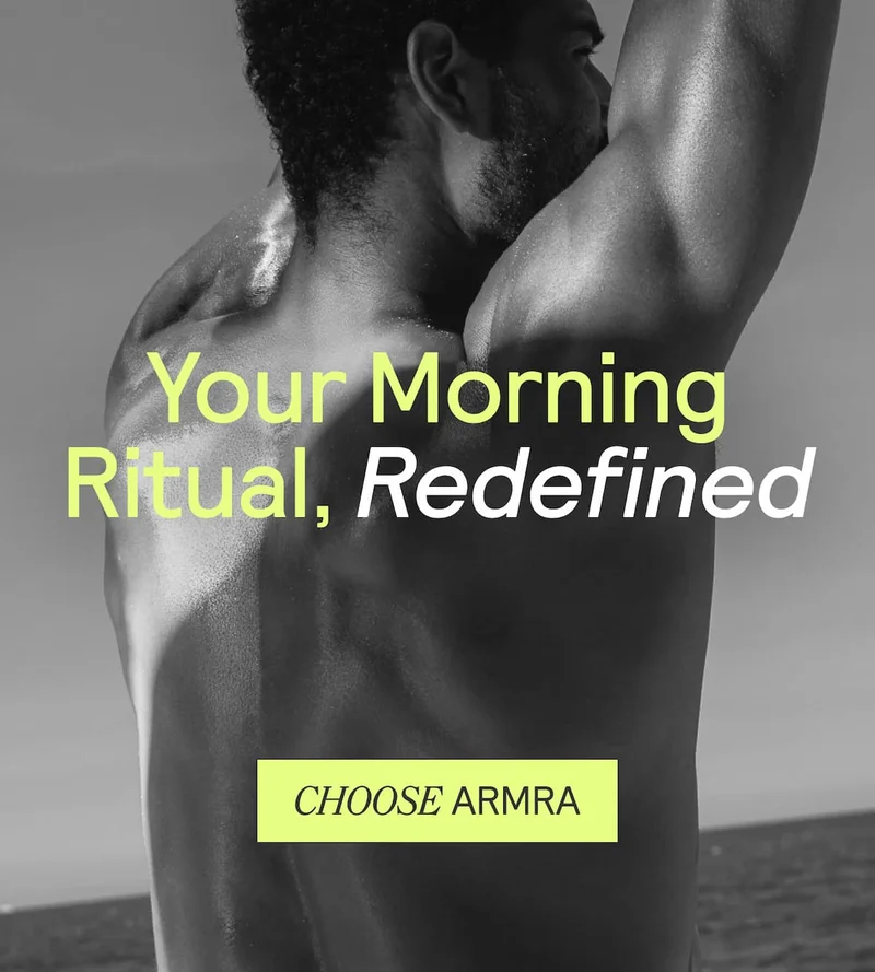 A man stretching by the ocean with the text “Your Morning Ritual, Redefined.” A bright yellow button reads “Choose ARMRA.”