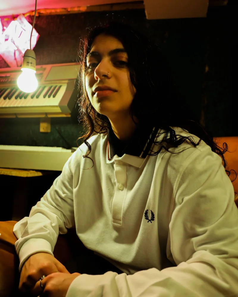 Fred Perry Ambassador wearing a long sleeved Fred Perry Shirt in a music studio