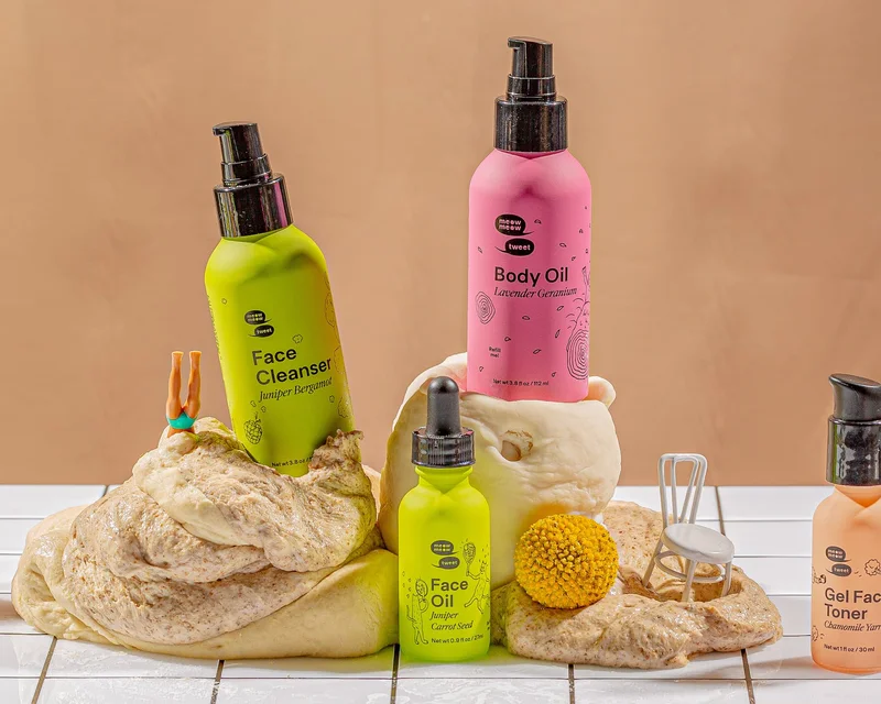 A collection of personal care on a tan background with mushy dough on the bottom