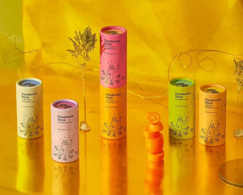 A collection of colorful paper tube deodorants in a yellow background