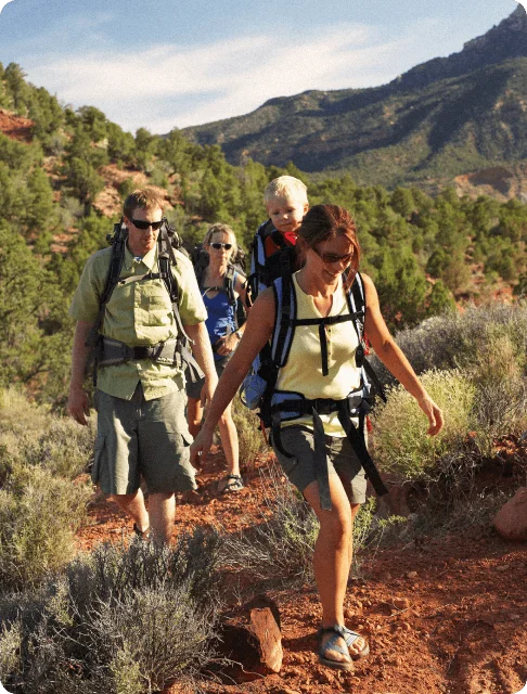 Image Description: A family of four hiking through desert shrubs in Sedona