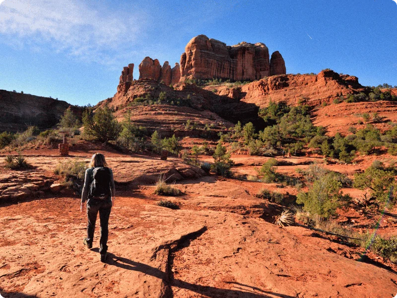 Image Description: A solo traveler hiking along the Cathedral Rock Trail in Sedona