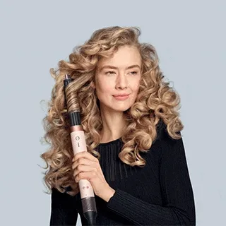 The Dyson Airwrap Co-anda2x various attachments being used to style models’ hair in different ways