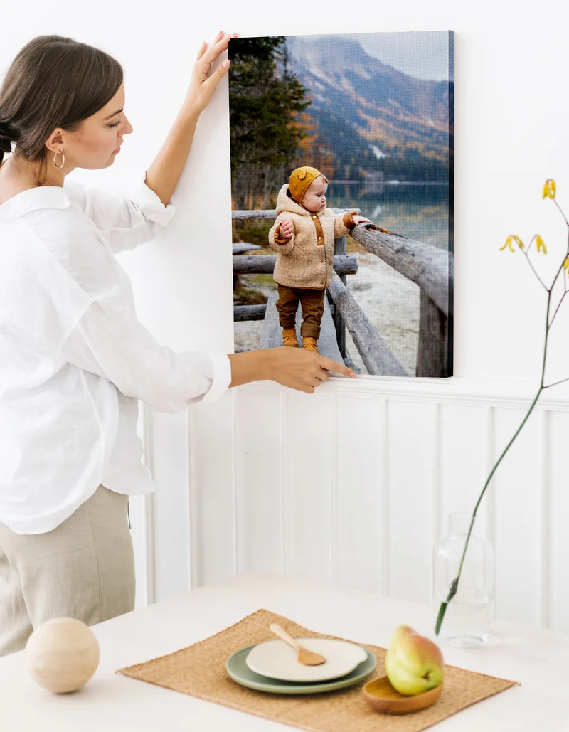 Photo of woman holding a canvas print of her baby.