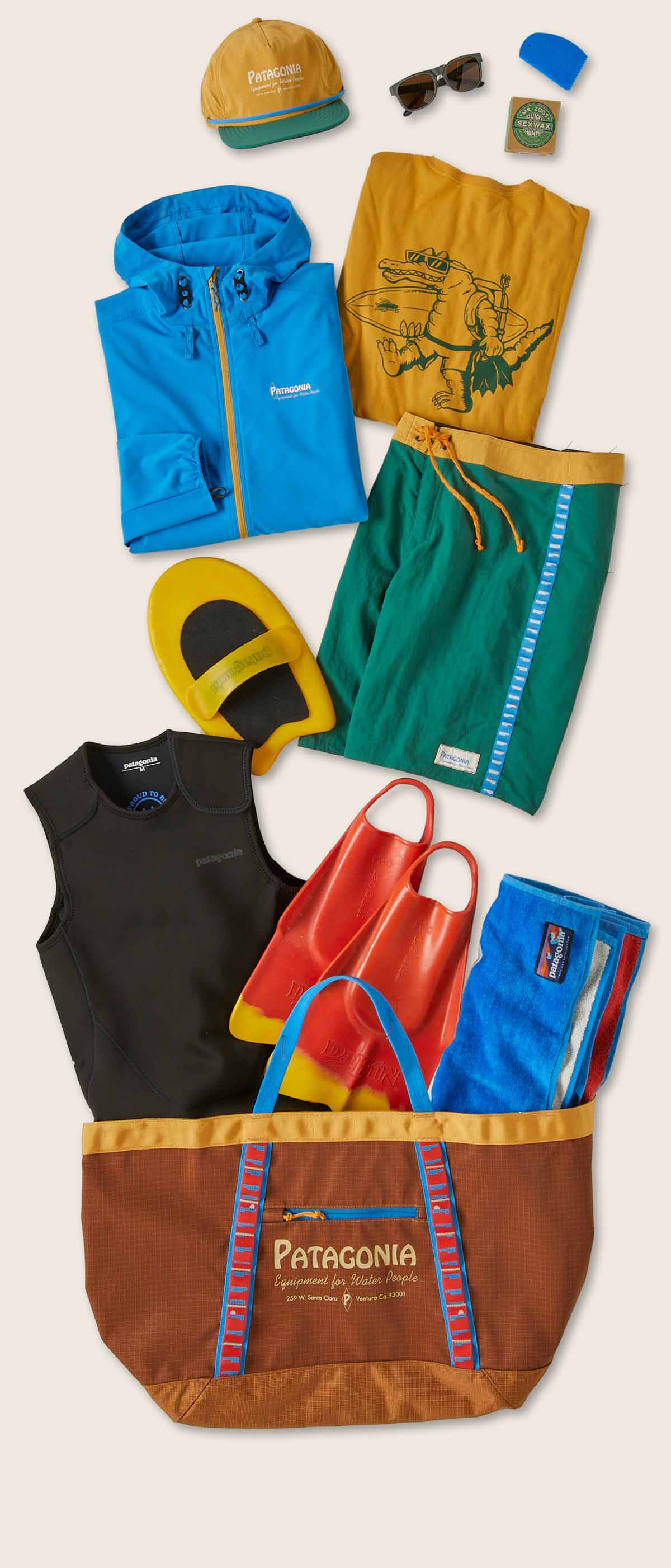 Various items for a day at the beach spill out of a tote bag.