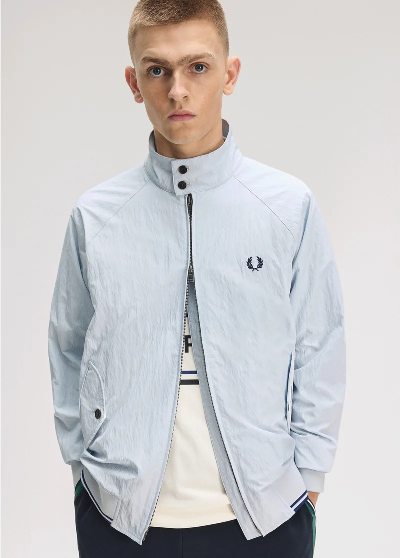 Male model wearing a Fred Perry Crinkle Harrington Jacket in Dusky Blue