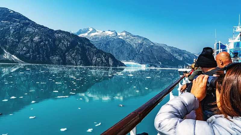 Image description: Tourists enjoying the view Glacier Bay National Park and Preserve, Alaska.