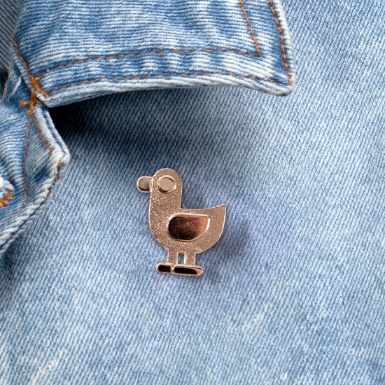 Close Up of the Golden Duck Pin on a Jacket