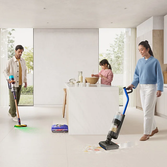 A family kitchen with child baking, and parents using Dyson cleaning technology, plus robot vacuum
