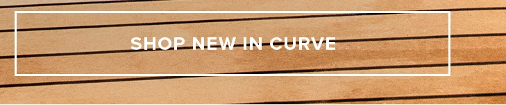 SHOP NEW IN CURVE banner. Warm wooden plank background.