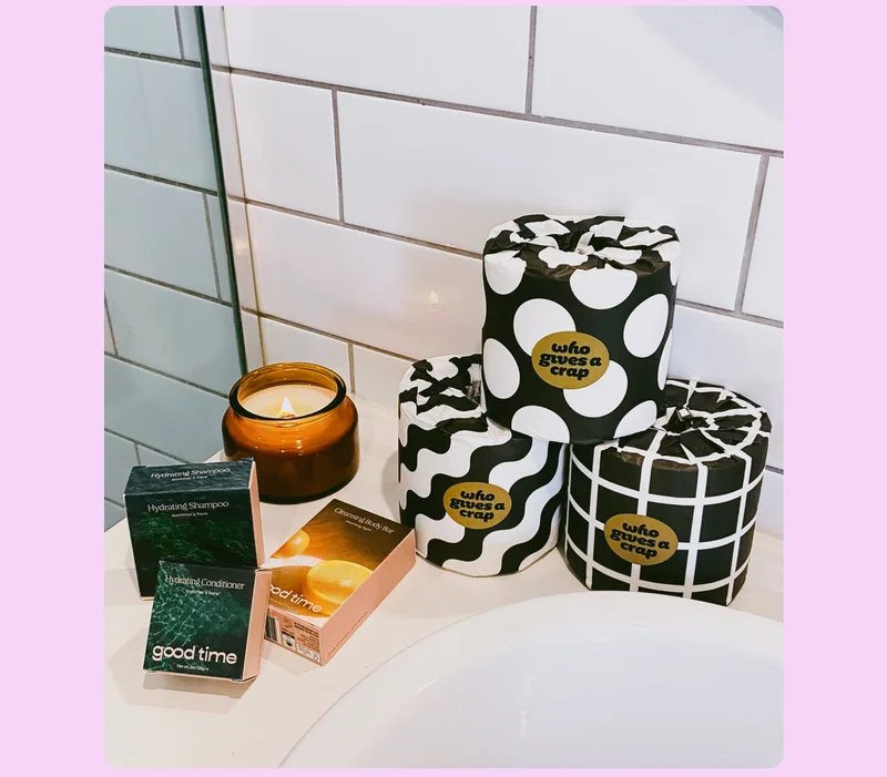 Image: A match made in the bathroom. Who Gives A Crap toilet paper with Good Time Hydrating Shampoo, Hydrating Conditioner, Cleansing Body Bar and a candle