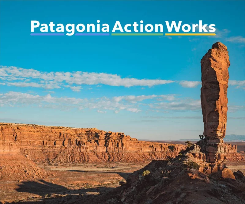 Two climbers approach a steep rock face in Bears Ears National Monument, Utah.