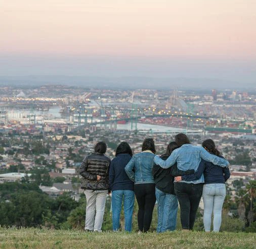 Support frontline communities. Youth activists look out over the oil and gas infrastructure that surrounds their neighborhood.