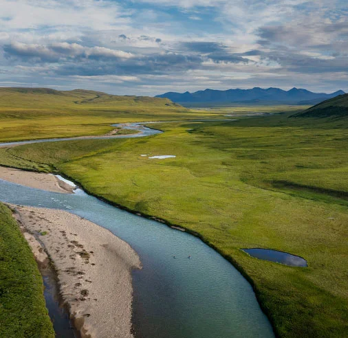 Help save our public lands. Packrafters float down a river in Alaska’s National Petroleum Reserve.