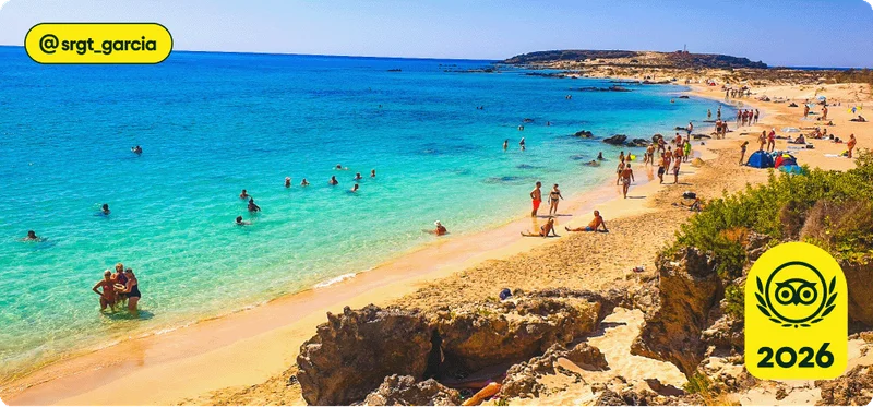 Image Description: People swimming and lounging at Elafonissi Beach in Crete.