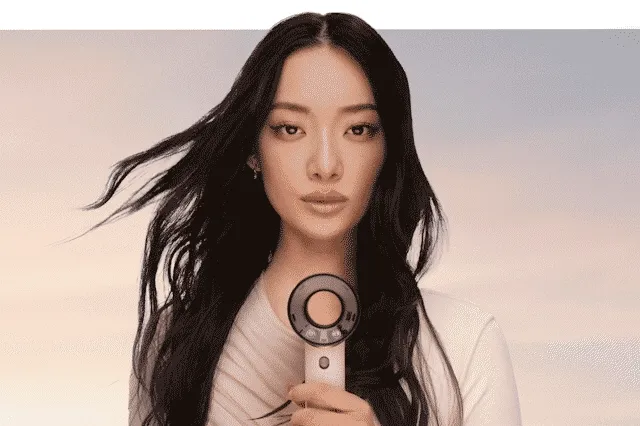 A model holds the Dyson Supersonic Travel hair dryer