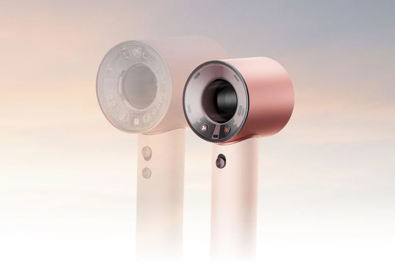 Dyson Supersonic Travel hair dryer in front of a larger Dyson Supersonic Nural hair dryer