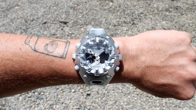 Image may contain: Wristwatch, Arm, Body Part, Person, Hand, Wrist, Adult, Skin, and Tattoo