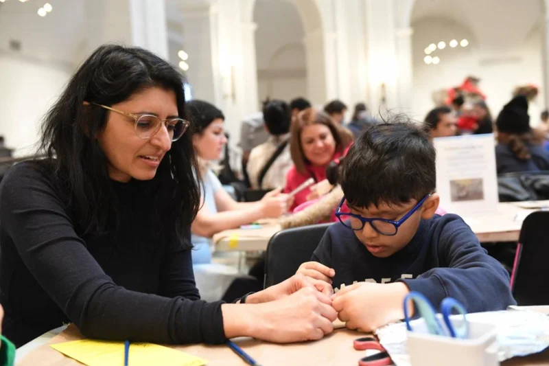An adult and child making art together
