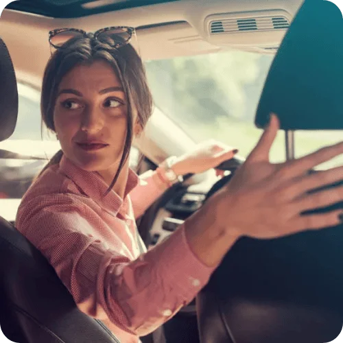 woman looking behind her in the car woman looking behind her in the car