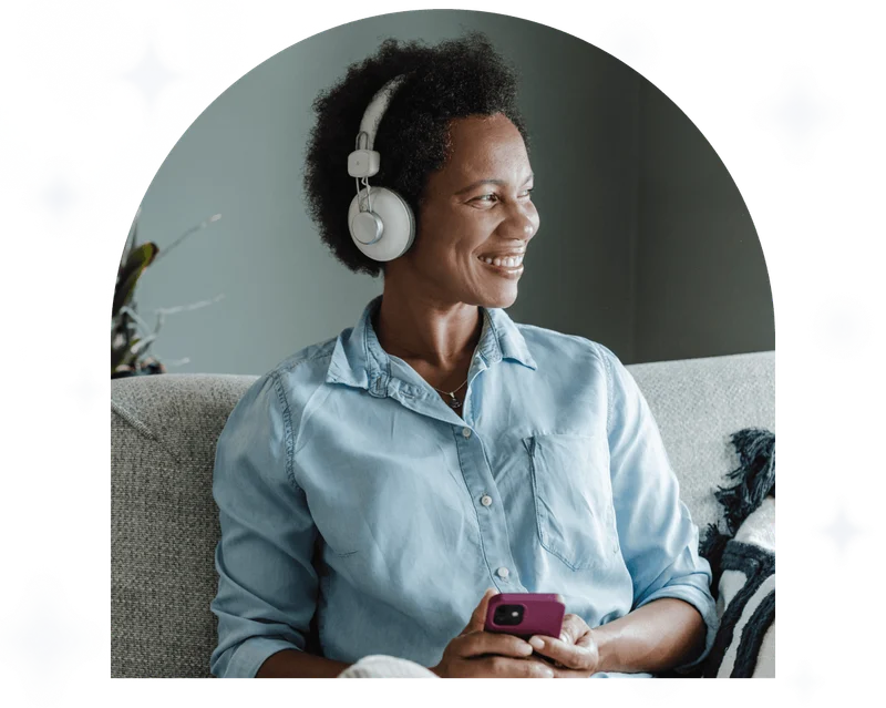 Woman enjoying free time on the sofa listening to Calm on phone