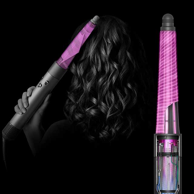 Model curling hair with the conical barrel attachment.