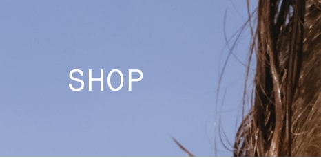 'SHOP' in white text on blue background beside strands of hair.