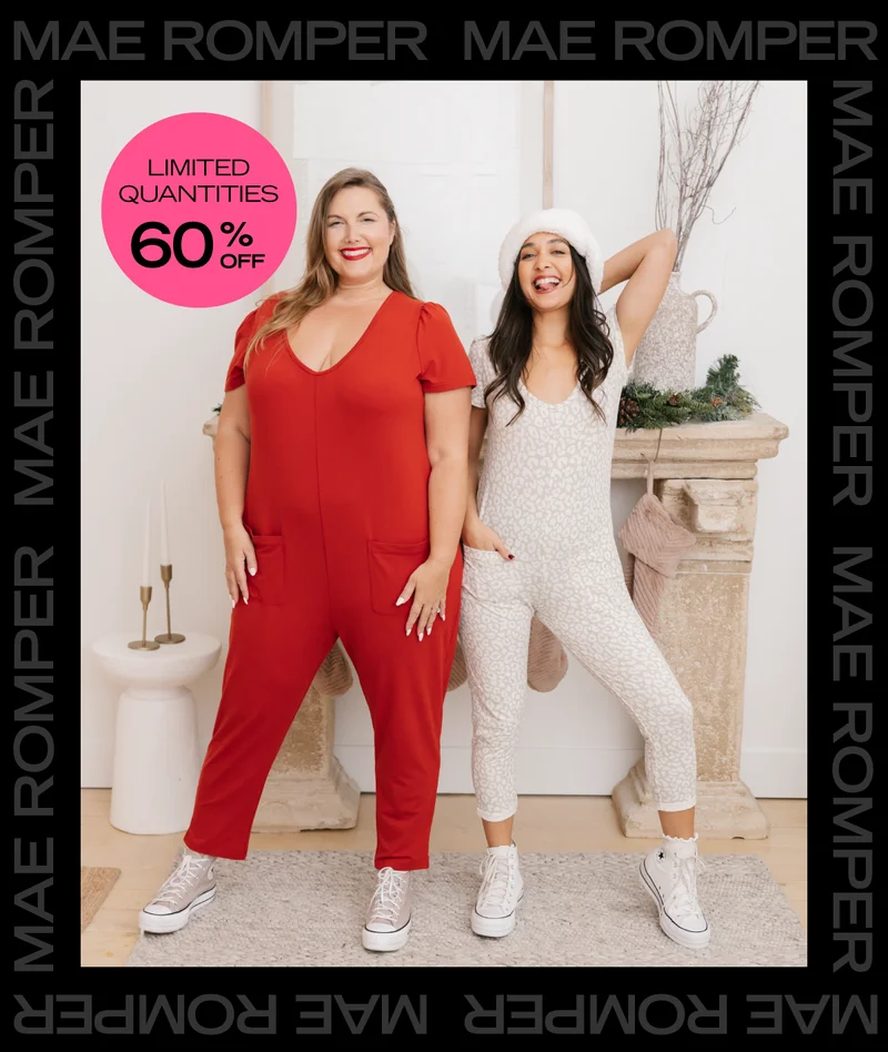 2 models wearing red and leopard print rompers in front of fireplace