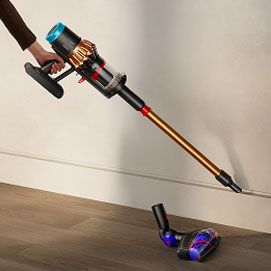 The Dyson V16 Piston Animal vacuum cleaner used with the wand and a built-in dusting tool.