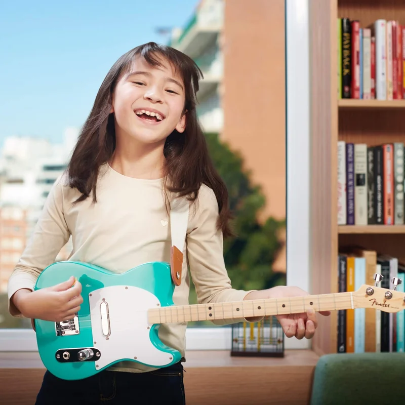 Girl playing Fender x Loog guitar