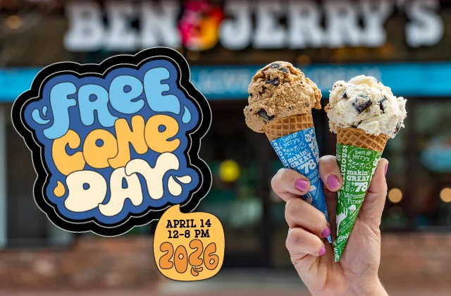 Hand holds two cones in front of a Ben & Jerry's Scoop Shop. Text reads: Free Cone Day April 14, 2026 12-8pm.