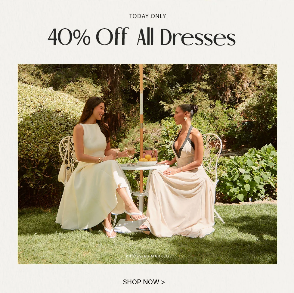 Elegant cream and beige tea party dresses shown on two women enjoying an outdoor garden gathering. Shop perfect formal attire.