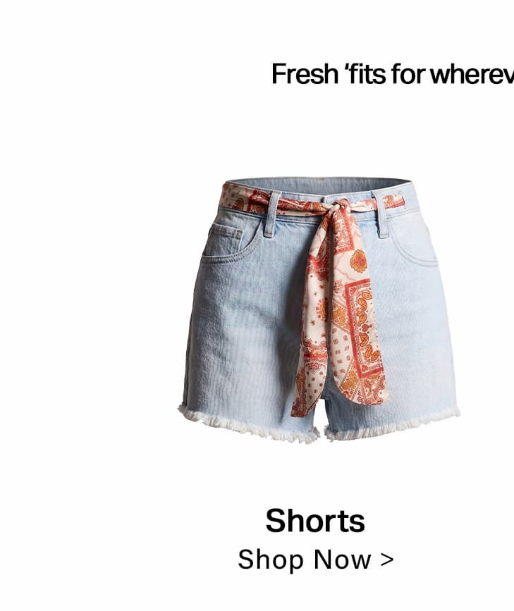 Light blue denim shorts with frayed hem, styled with an orange patterned scarf belt. Shop our new summer collection for fresh styles.