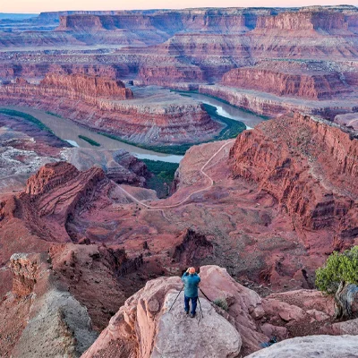 A man taking photographs of a canyon