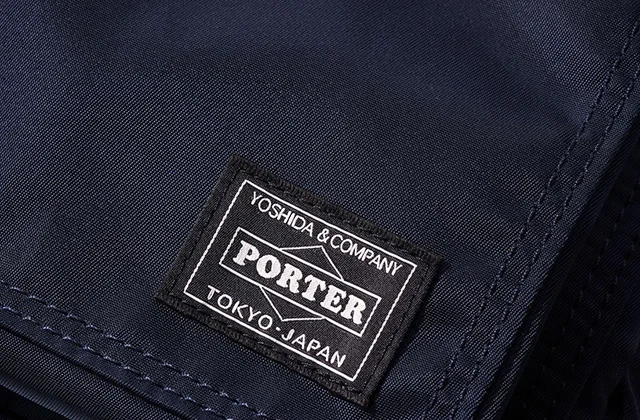 An extreme close up of the PORTER authenticity label on the shoulder bag
