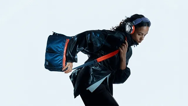 Model showcases Dyson OnTrac and PORTER custom shoulder bag in an active position