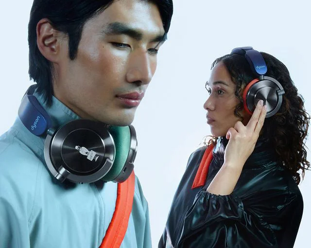 A model wears the Dyson OnTrac headphones with the PORTER emblem etched on the right cap