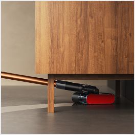 The Dyson PencilWash cleaner is used to clean underneath a low cabinet