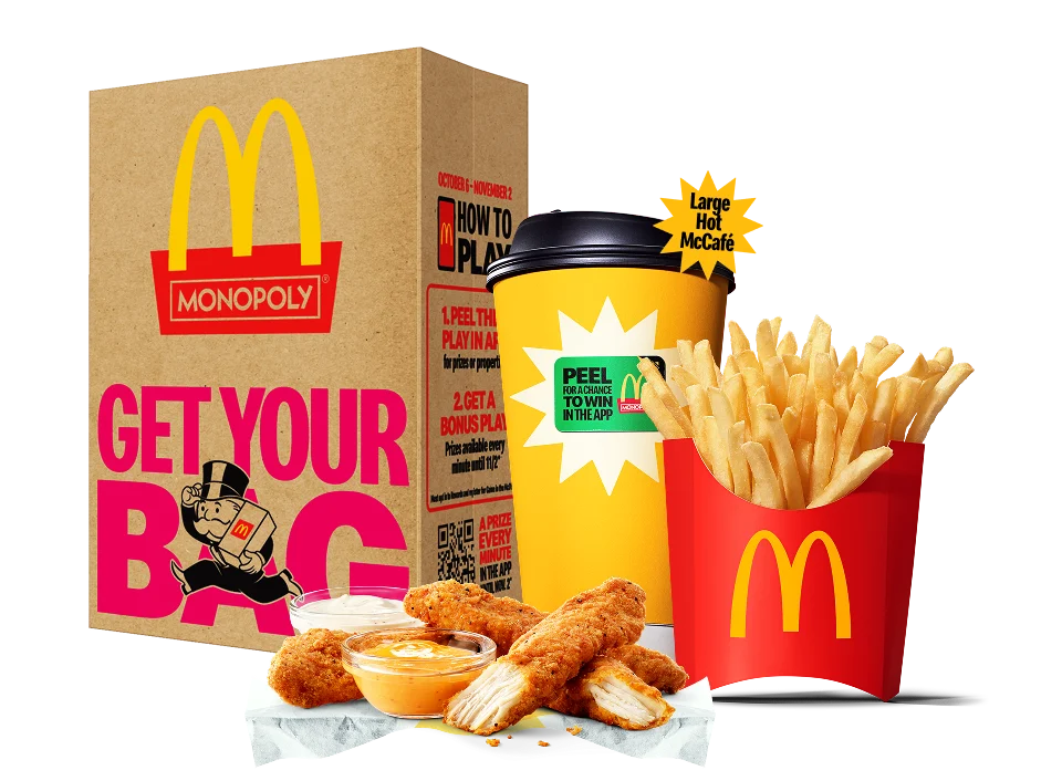 Image of 4 piece McCrispy Strips, Medium Fries, and a Large Hot McCafé in front of a McDonald’s bag.
