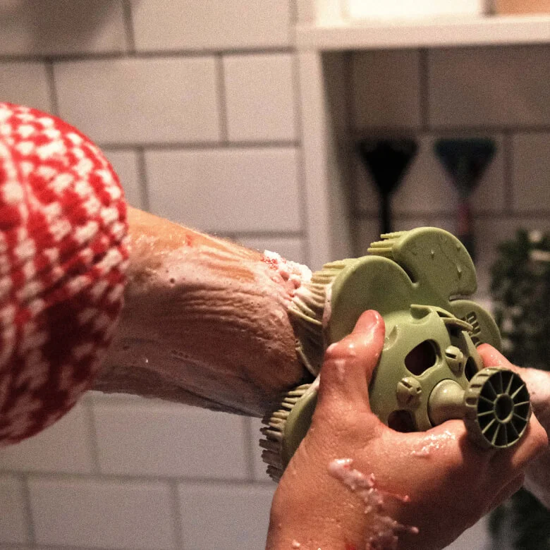 Person lathering up their arm with a green smoosh
