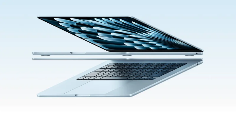 Two open MacBook Air laptops in sky blue color forming arrow shape, emphasizing narrow profile