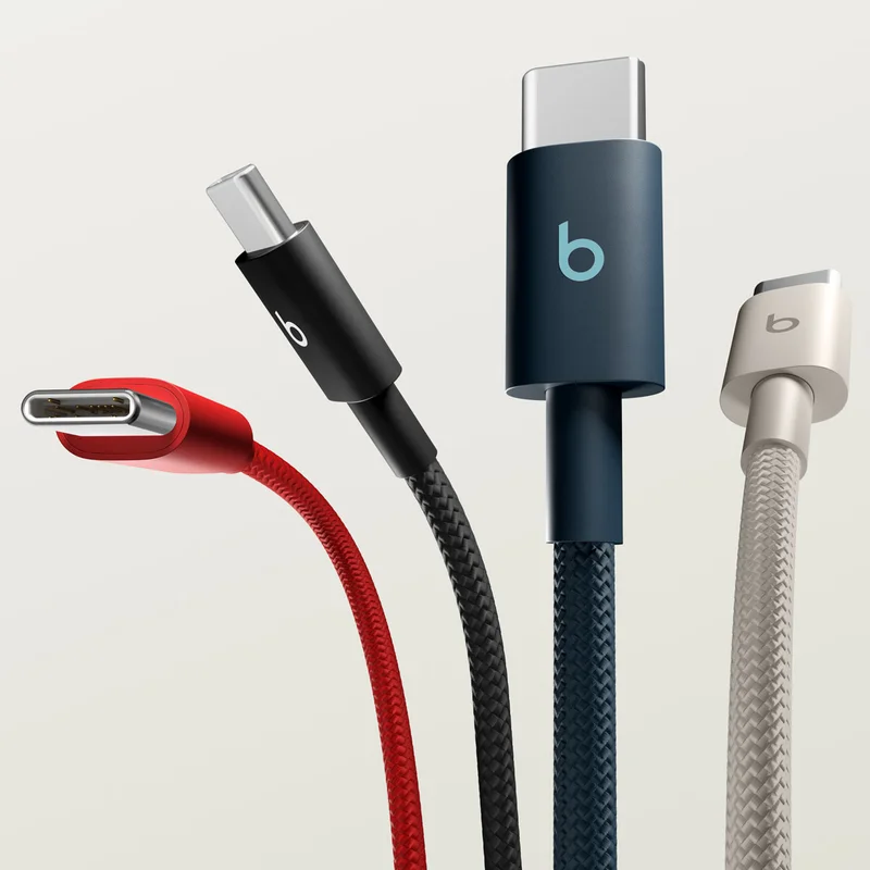 Beats Cable in Nitro Navy plugged into an iPhone laying on a table.