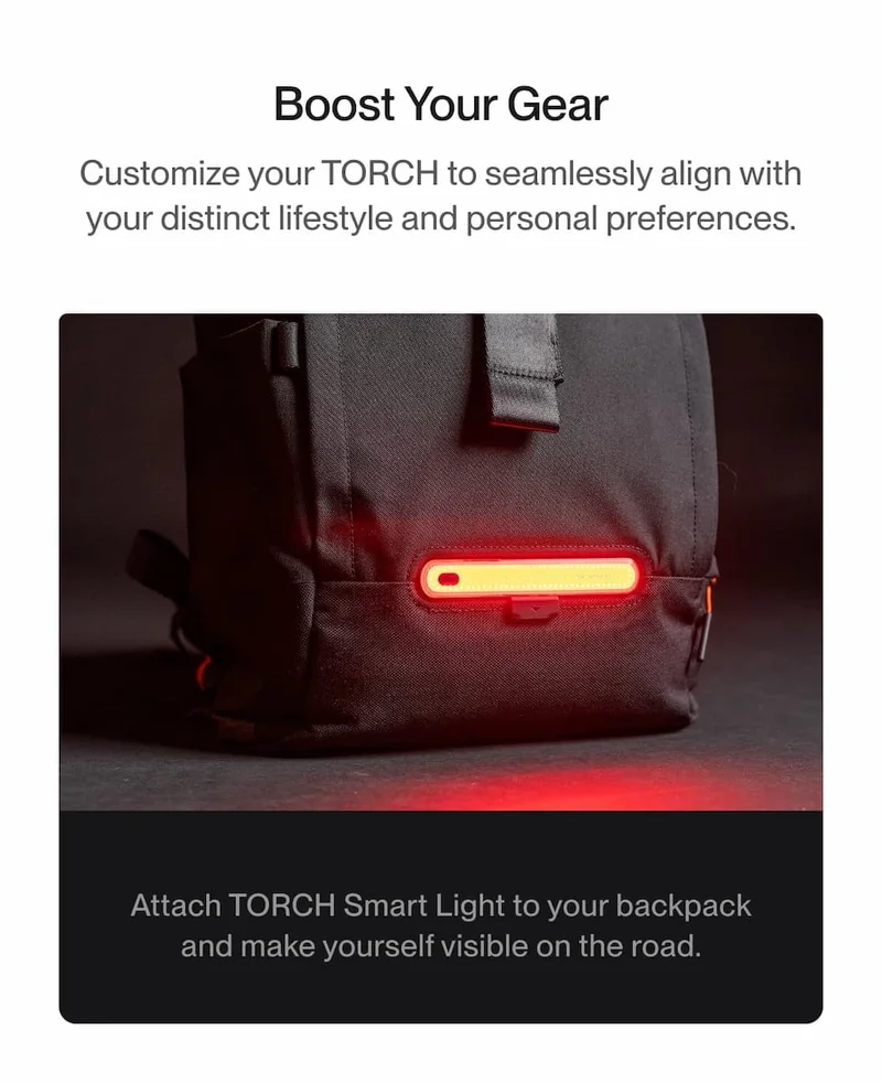 Close-up of TORCH backpack with Smart Light attached, glowing red for enhanced road visibility.